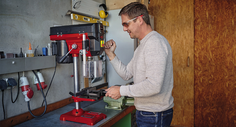 Man useing bench drill