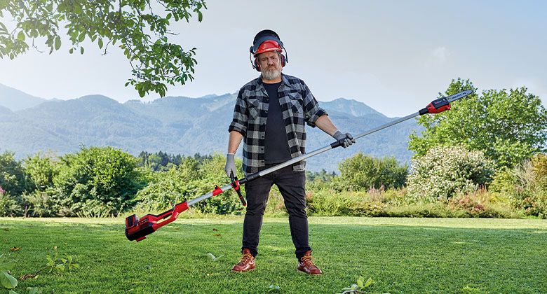 man holding a pole saw